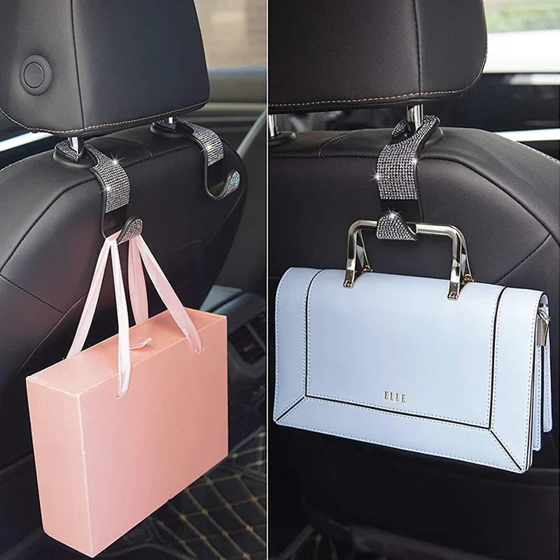Rhinestone Car Seat Back Hook holding a pink gift box and a blue handbag, adding style and organization to car interiors.