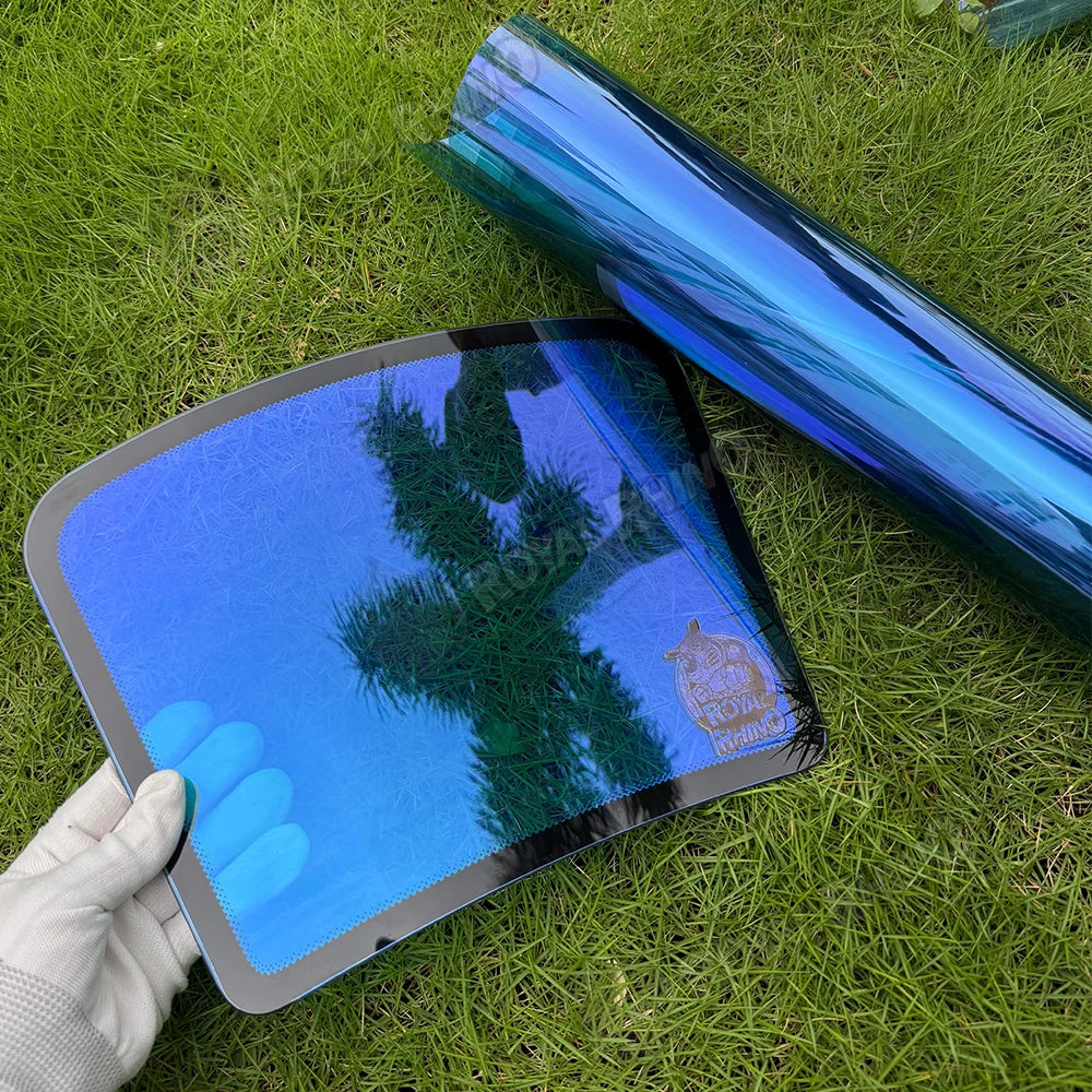 Chameleon Blue Reflective Windshield Film displayed on grass, showcasing its striking color and reflective properties.