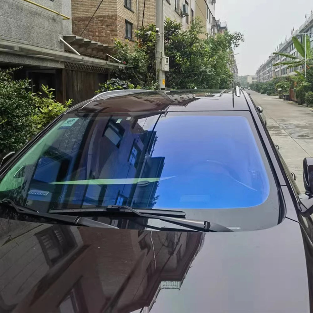 Chameleon Blue Reflective Windshield Film on a dark SUV, showcasing its vibrant color gradient and solar protection.